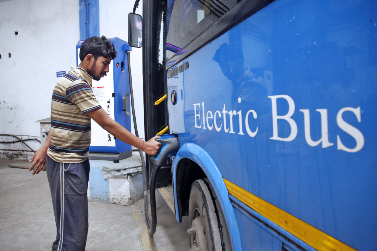 Kolkata, India: An electric bus is charged at a government bus depot