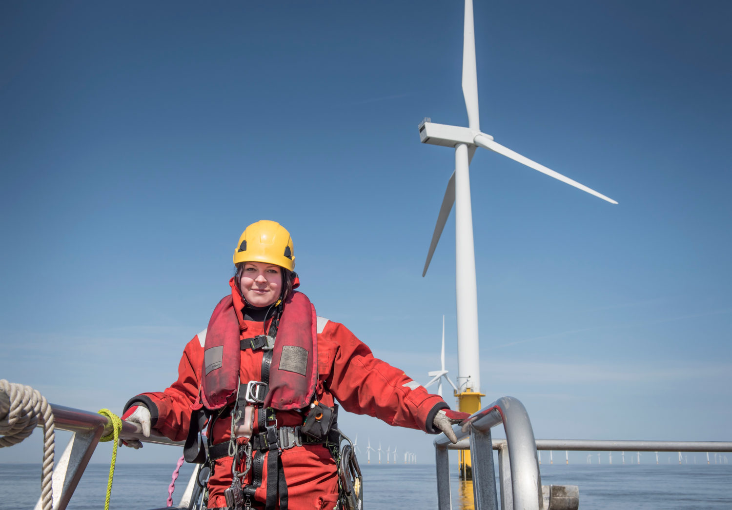 Portrait of female engineer on boat at offshore windfarm