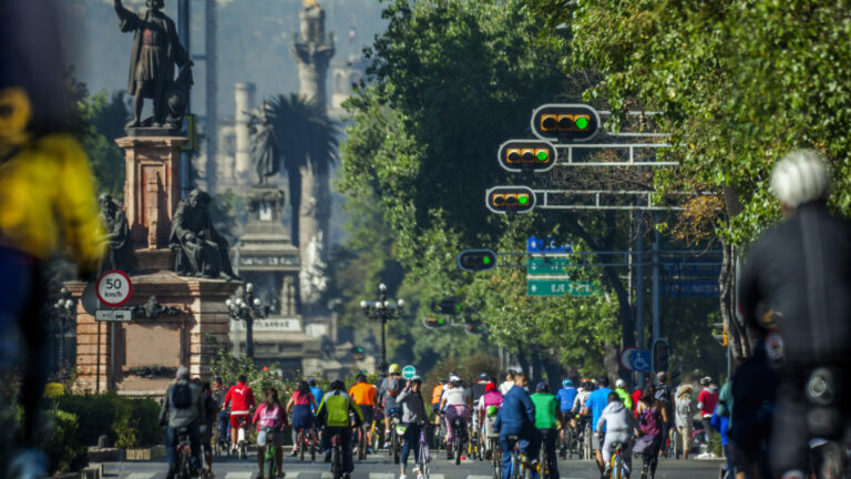 Reforma avenue Skyline in Mexico city and people riding bicycles
