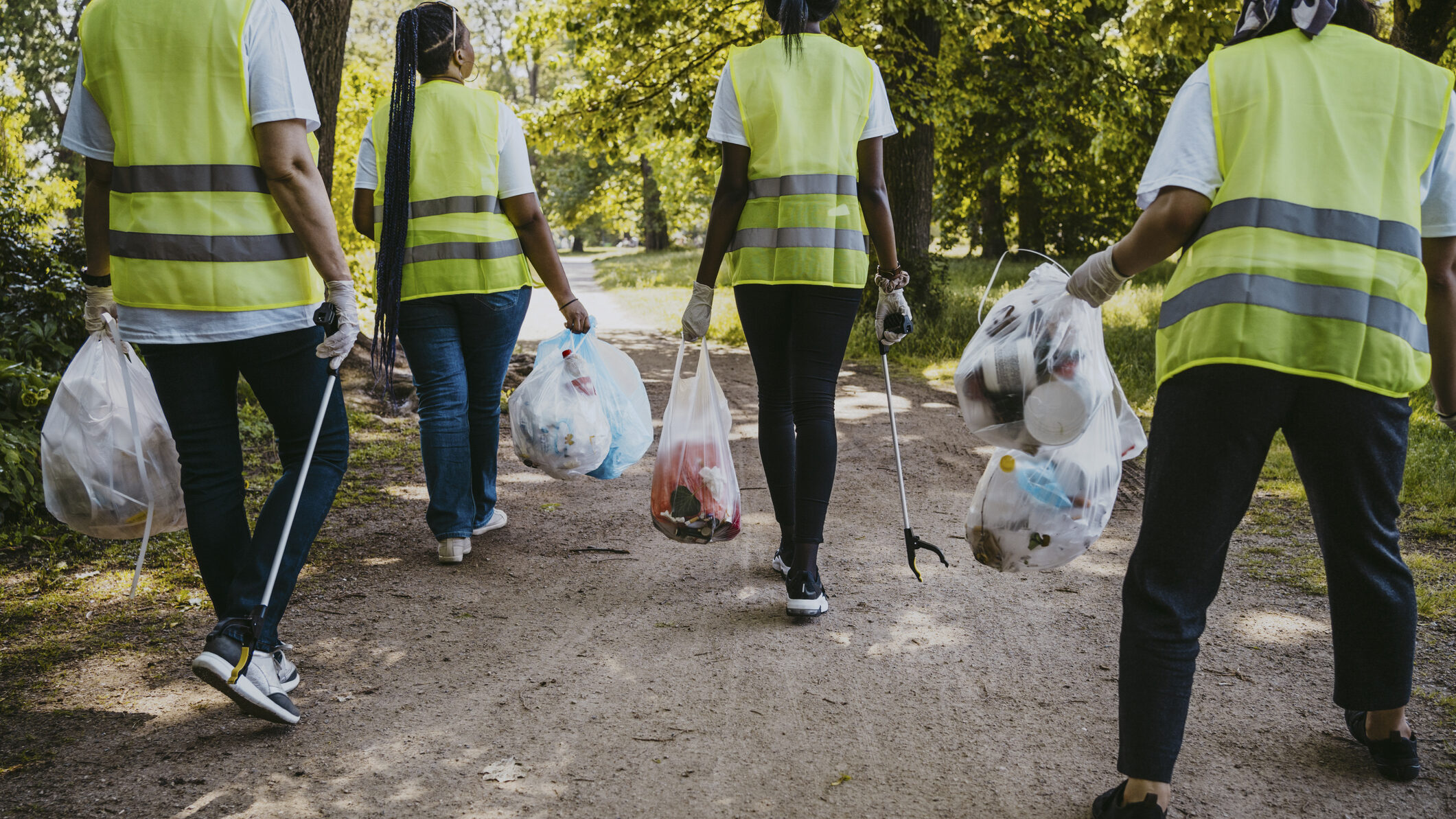 Female environmentalists collect waste and recycling in park in Berlin